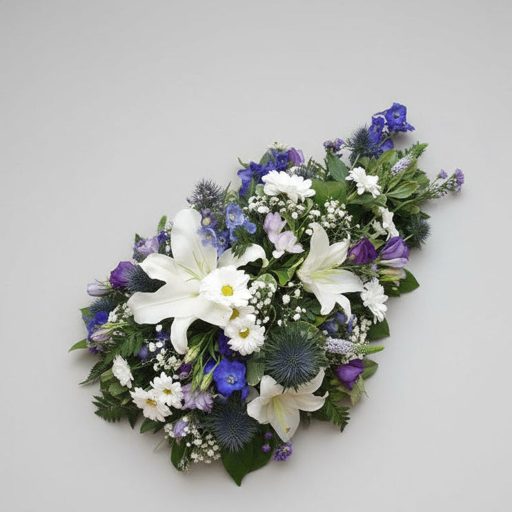 Blue & White Seasonal SprayFuneral Tribute