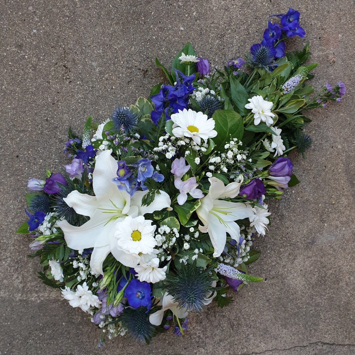 Blue & White Seasonal SprayFuneral Tribute